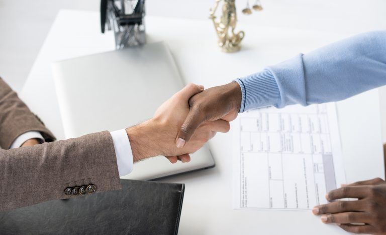 A handshake between a client and franchise lawyer.